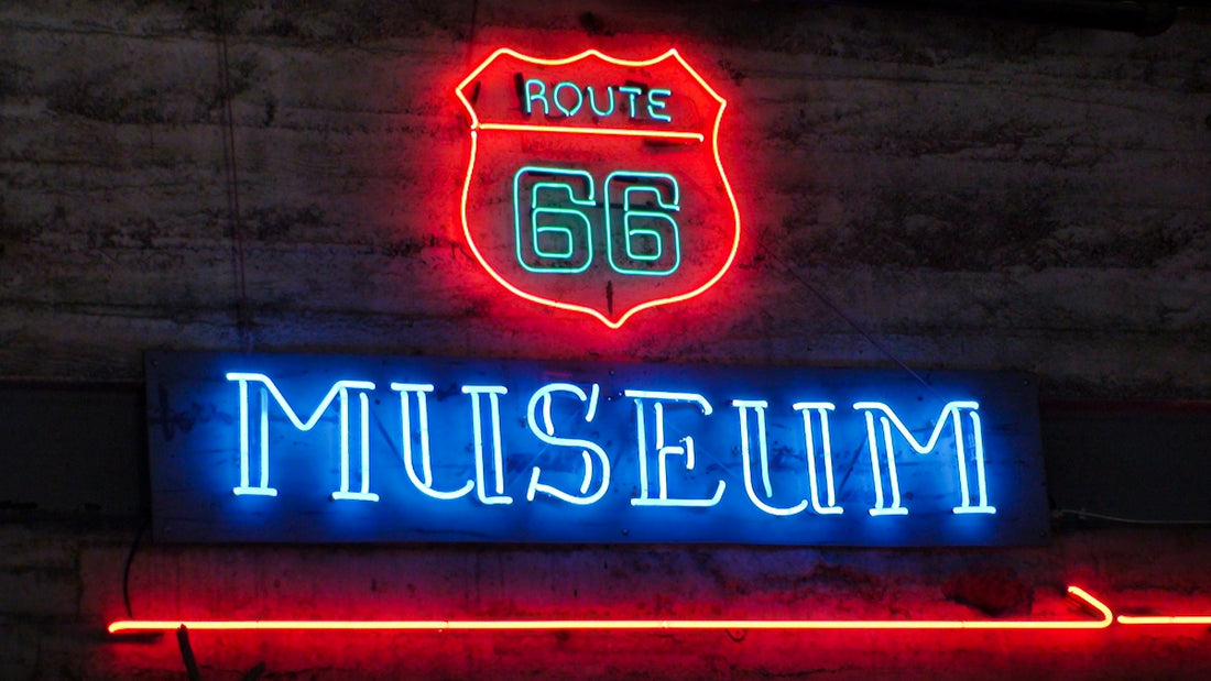 Neon route 66 museum sign glowing brightly on a wall